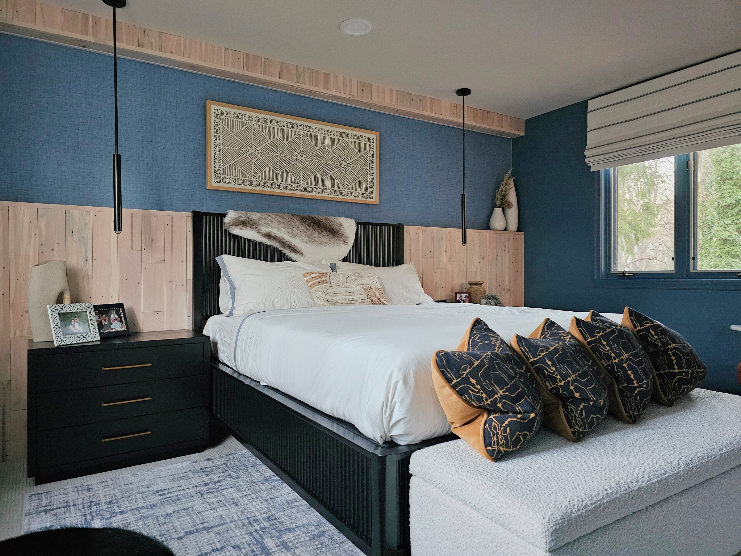 a bedroom with blue walls and a black headboard design by bespoke by ali fasi interior design, philadelphia, main line